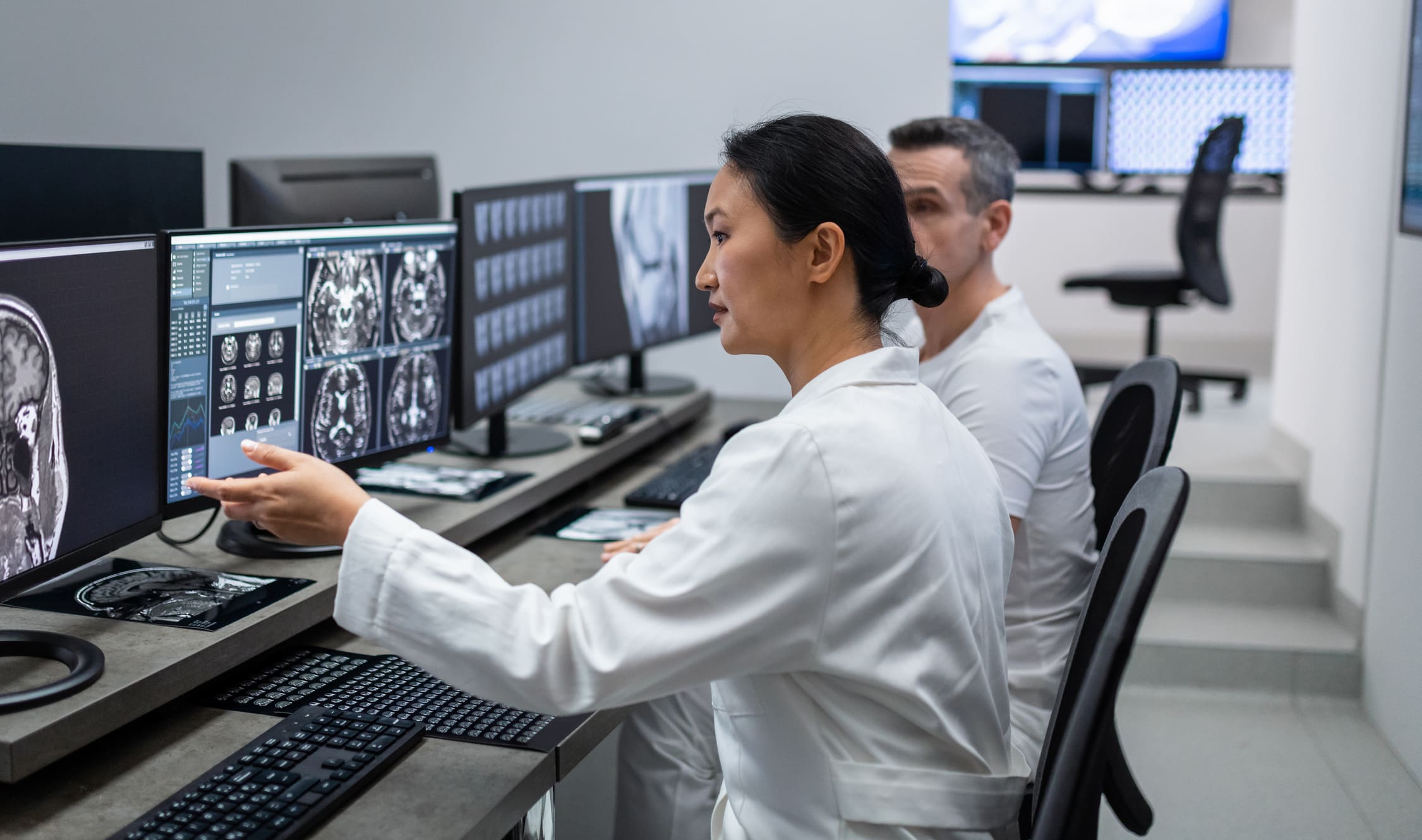 Radiologists examining digital brain images